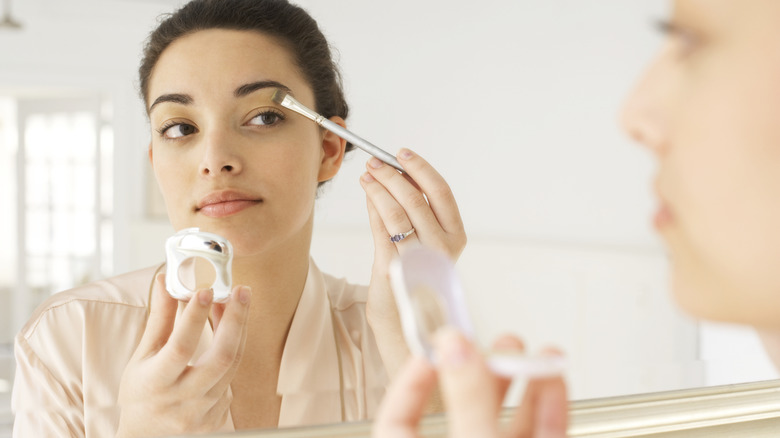 Woman applying eyeshadow