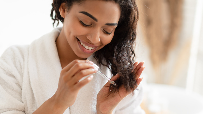 Woman using hair oil.