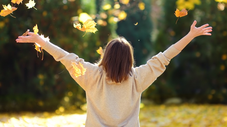 Woman enjoying forest with arms spread