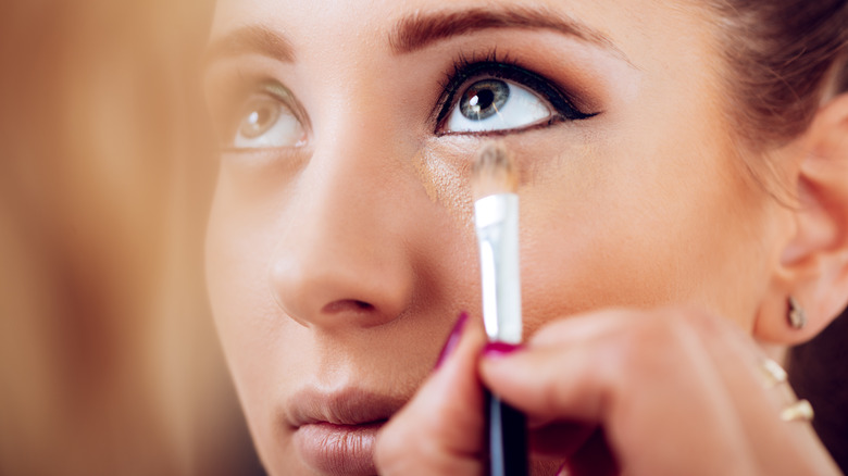 Woman getting her makeup done