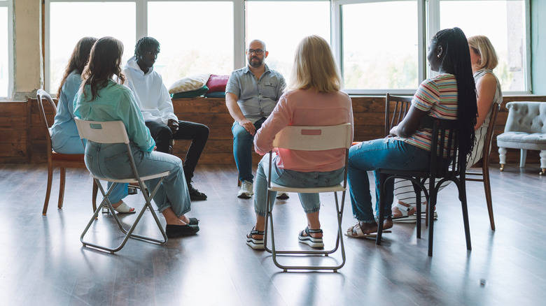 A group of folks in an AA meeting