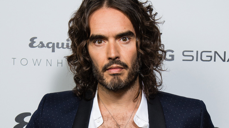 Russell Brand, bearded, shirt open