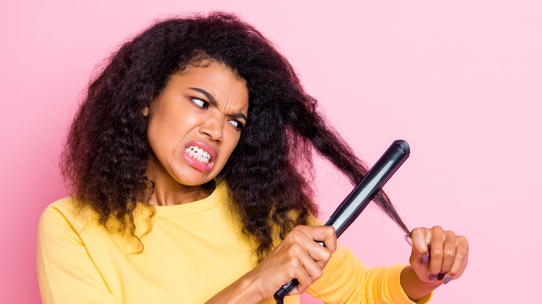 woman ironing her hair