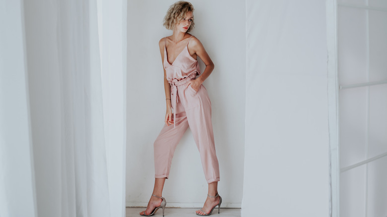 Woman wearing jumpsuit with heels