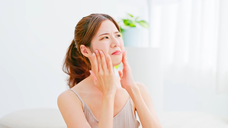 woman touching skin