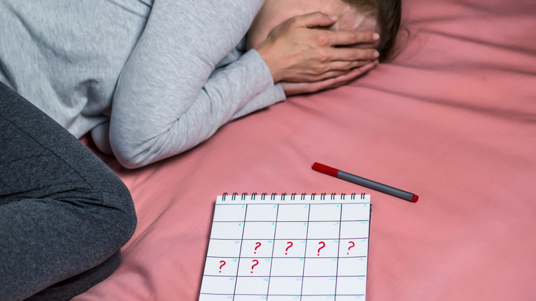 Woman crying by calendar