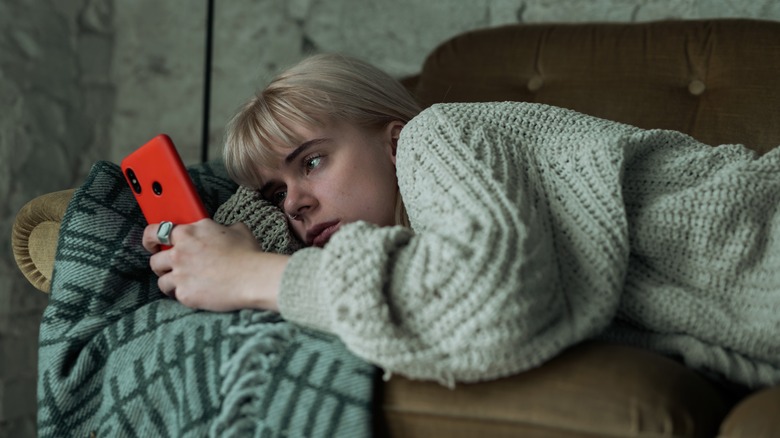 Unhappy woman looking at phone