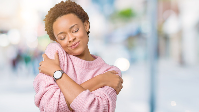 woman hugging herself