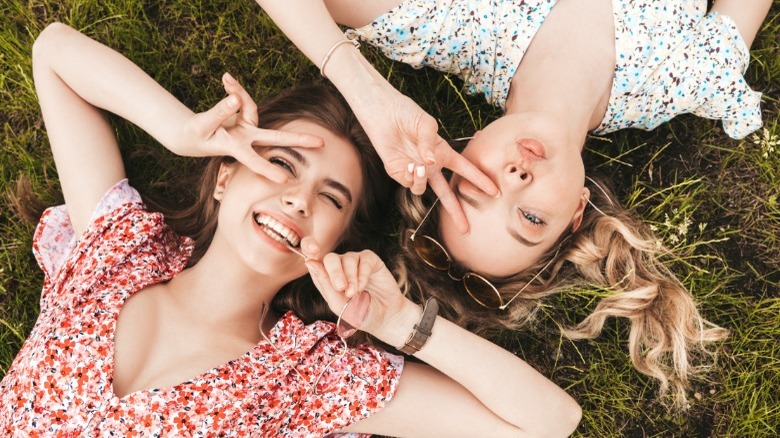 Two women lying down laughing