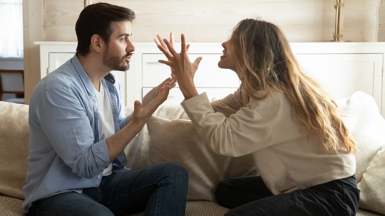 arguing couple on sofa