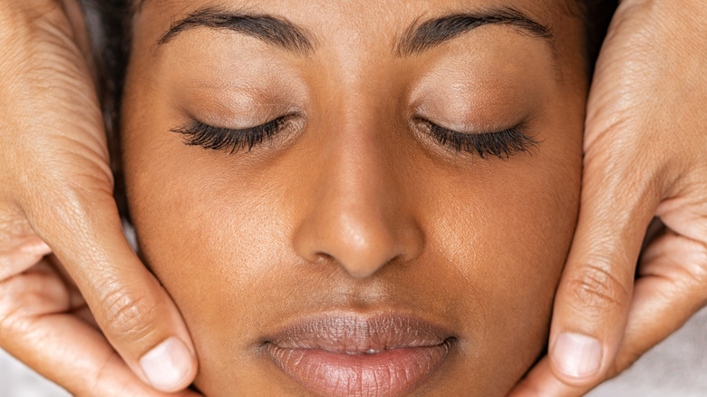 Woman getting facial massage