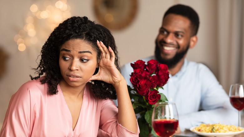 Woman turning face away from man 