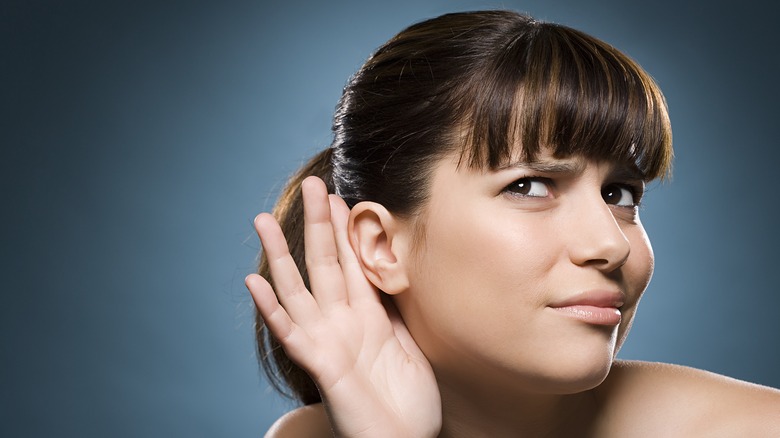 woman having difficulty hearing 