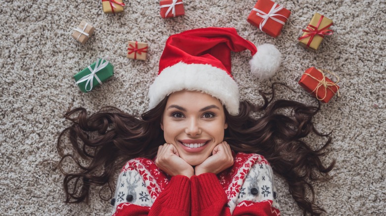 Smiling woman surrounded by gifts