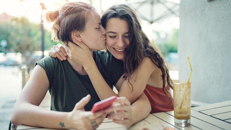 Flirty couple at cafe table