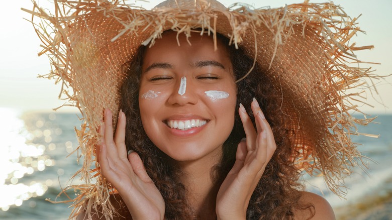 Woman wearing hat and sun block