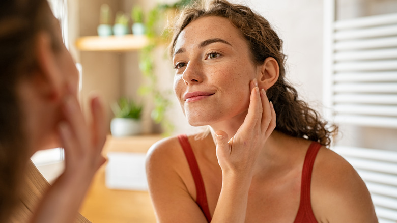 Woman looking at her skin