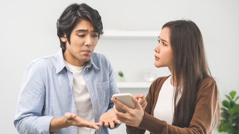 Couple with phone arguing