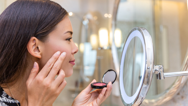 Woman applying contouring makeup