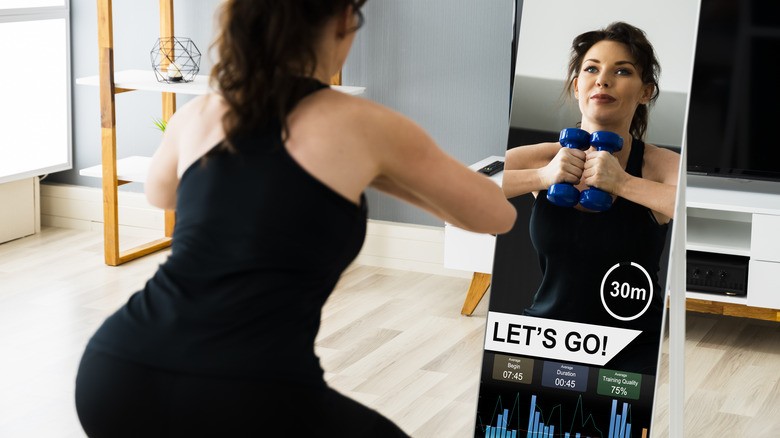 woman exercising in smart mirror