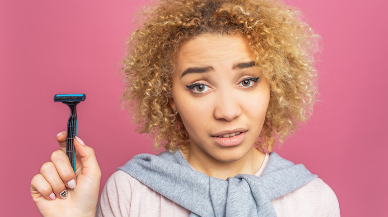 woman holding razor 