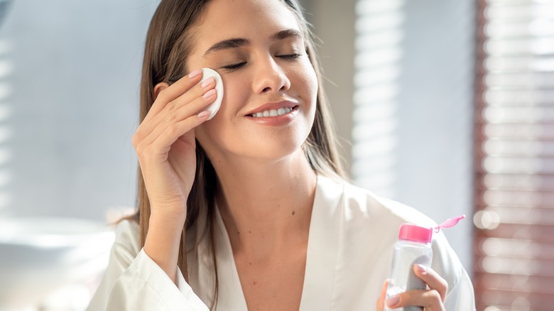 woman applying micellar water