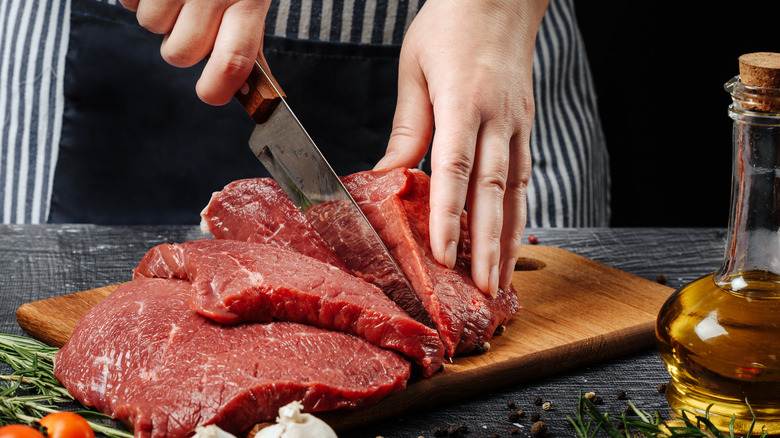 Cutting raw steak