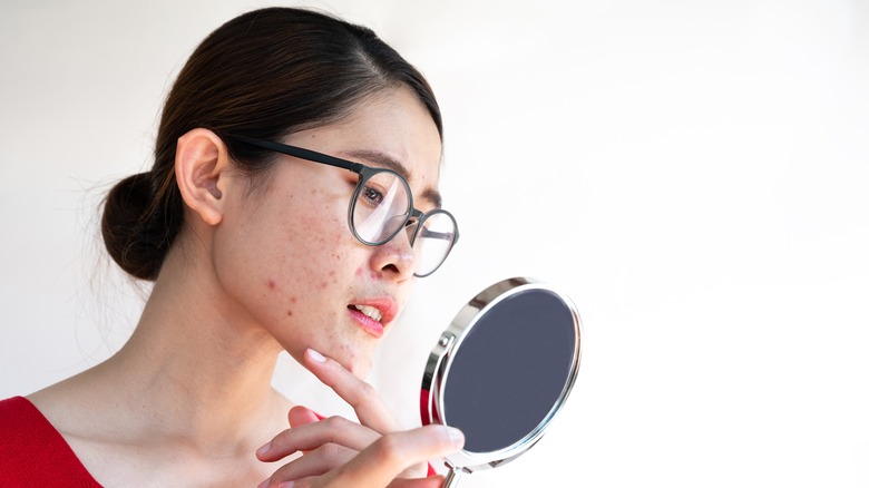 Woman looking in mirror