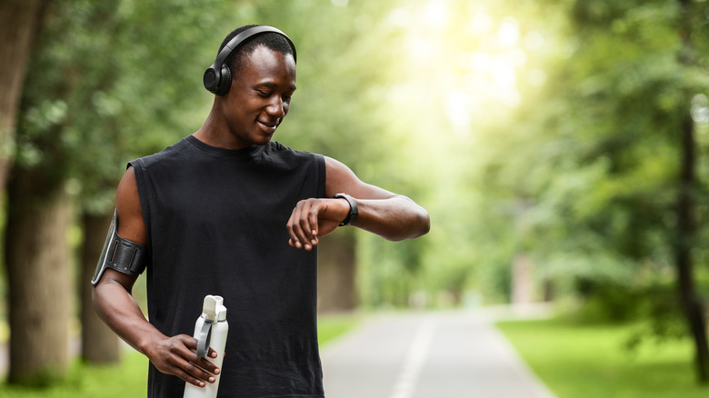 African American man checking his smart watch 