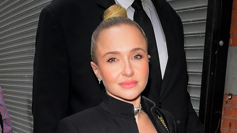 Hayden Panettiere walking with her hair pulled up into a bun