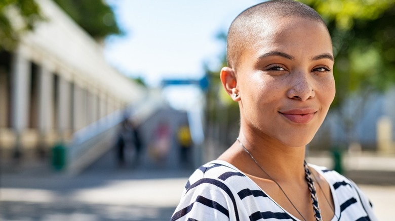 Woman smiling with shaved head