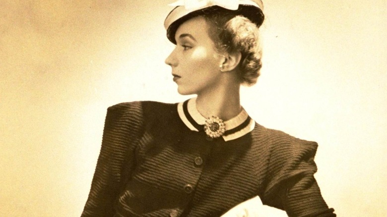 A portrait of a woman wearing an elaborate brooch, circa 1930s.