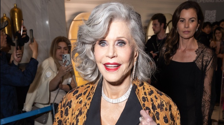 Jane Fonda wearing an animal-print outfit with red lipstick