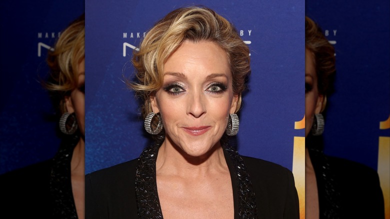 Jane Krakowski with a curly updo and big statement earrings