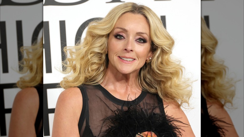 Jane Krakowski with a black translucent top and long styled curls