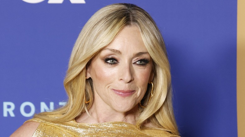 Jane Krakowski poses wearing a golden dress