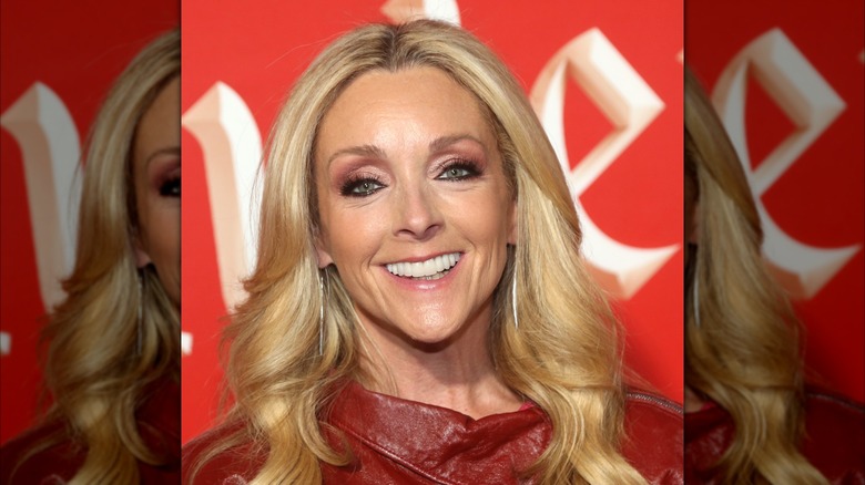 Jane Krakowski wearing a red top with long hair