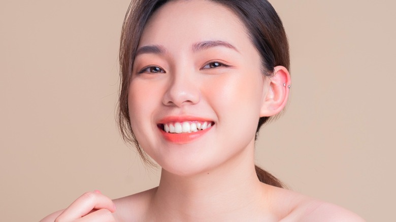 Smiling Asian woman wearing blush