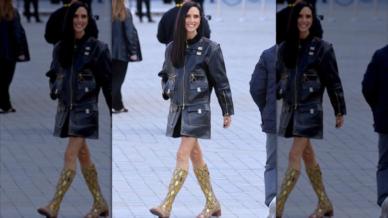 Jennifer Connelly struts with a black leather jacket and gold shiny boots