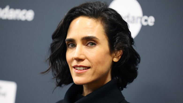 Jennifer Connelly smiles in a black turtleneck
