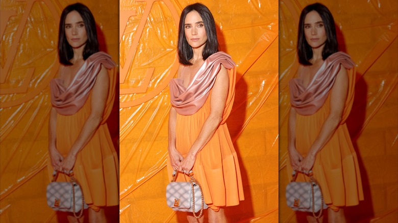 Jennifer Connelly poses in an orange dress