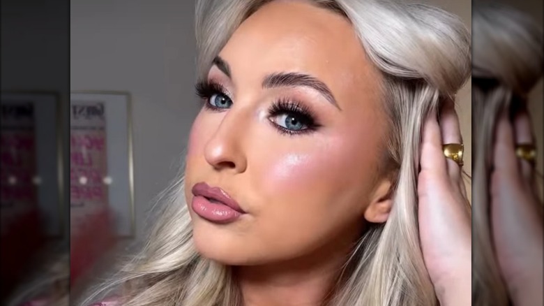 Woman with frosted eyeshadow and pink lipstick