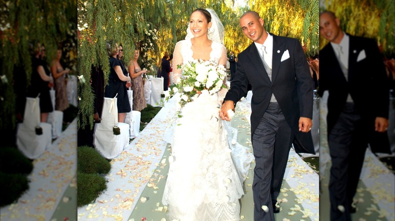 Jennifer Lopez smiling and holding a bouquet at her 2001 wedding with Cris Judd.