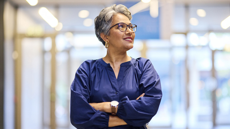 An older woman wearing large gold earrings