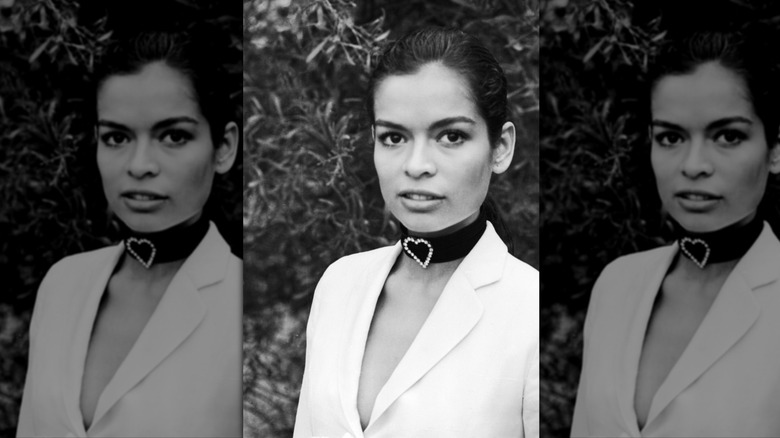 Bianca Jagger wearing a white blazer and a black choker