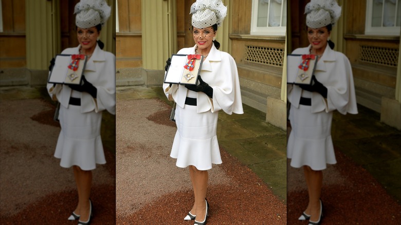 Joan Collins wearing a white dress