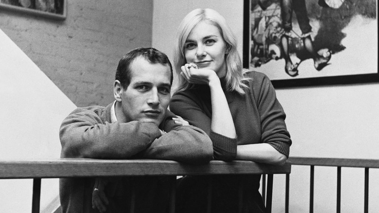 Paul Newman resting his head on his crossed arms and Joanne Woodward posing with her chin in her hand in 1961.