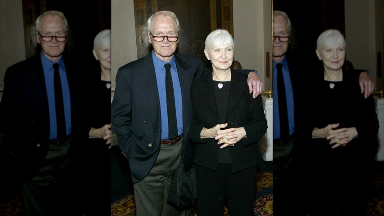 Paul Newman and his wife Joanne Woodward posing at an event.
