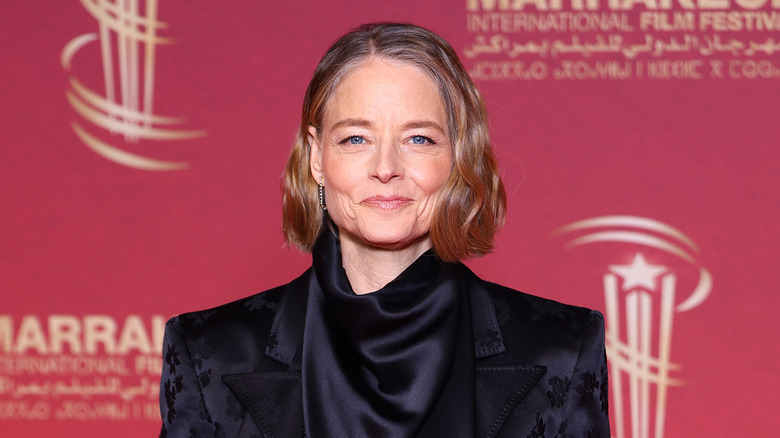 Jodie Foster wearing a black satin suit in 2025