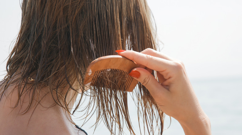 woman combing wet short hair
